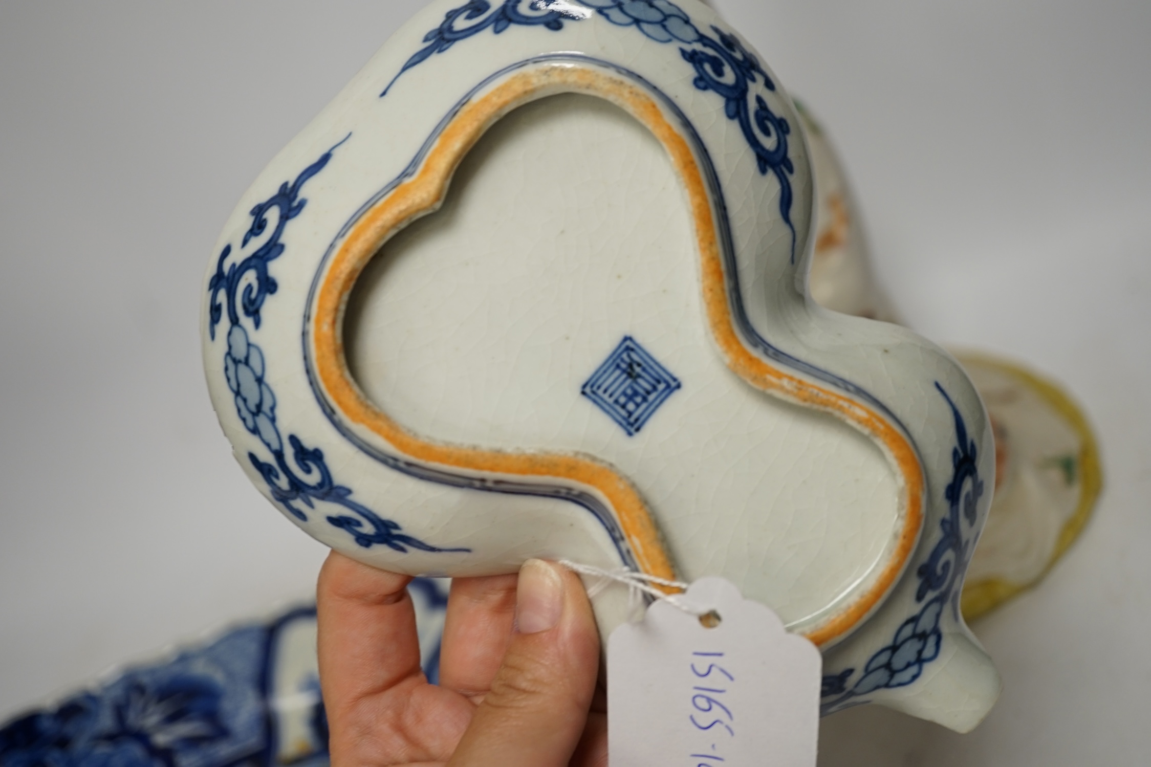 A Japanese seated porcelain figure of Kwannon, an Imari dish and a kakiemon style dish, largest 35cm diameter (3). Condition - blue dish good, others poor to fair